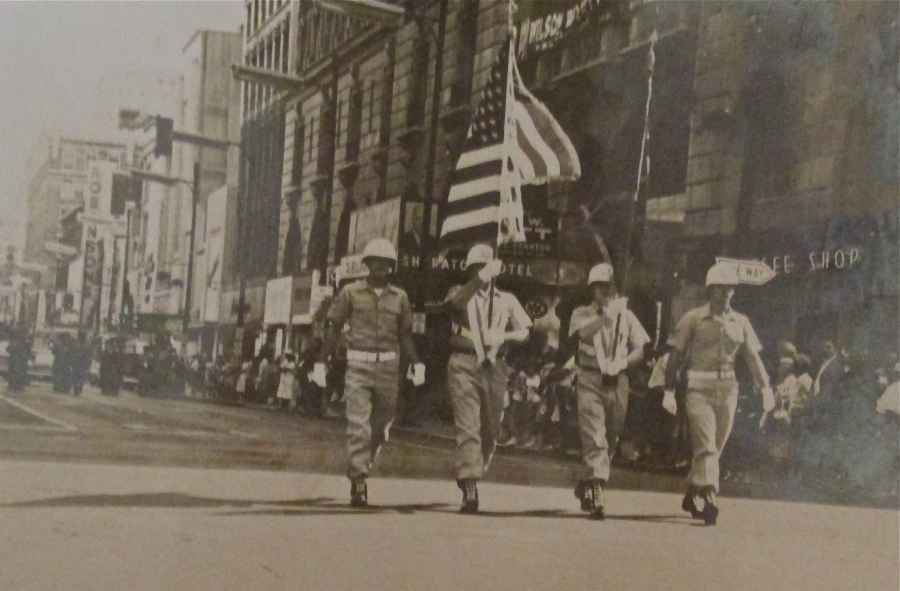 Sgt. Logsdon carries the American flag as part of a color guard in a parade in Louisville, Ky. honoring astronaut Gus Grissom. Photo provided